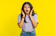 © Andrii Iemelianenko - Oh my God, Wow. Excited amazed winner woman raising hands in surprise looking at camera with big eyes, shocked by sudden victory celebrating success achievement good news. Girl on yellow background