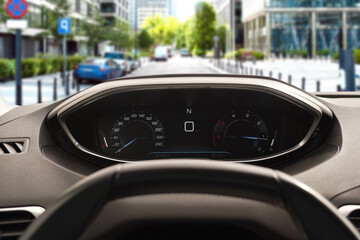 Wall Mural - Dashboard with speedometer behind steering wheel inside car