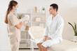© Pixel-Shot - Cosmetologist with photoepilator and young man in beauty salon
