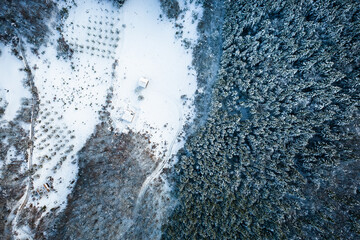 Aerial view of a winter snow-landscape. Winter forest texture. Aerial view. Aerial drone view of a winter landscape. Snow covered forest.