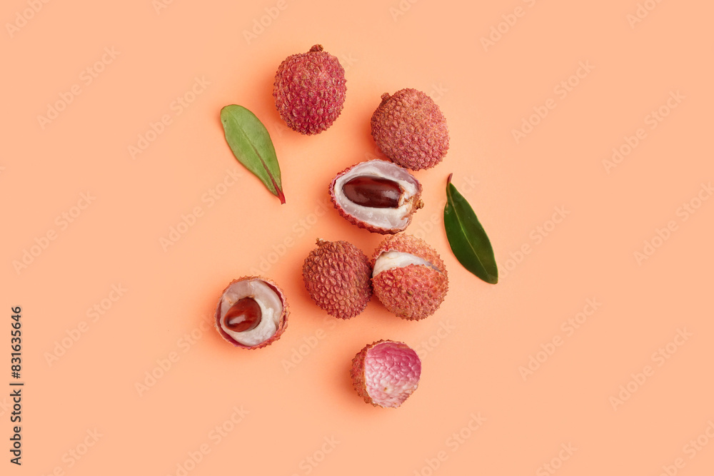 Tasty litchi fruit and leaves on beige background