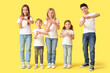 © Pixel-Shot - Group of cute kids making hashtag gesture on yellow background