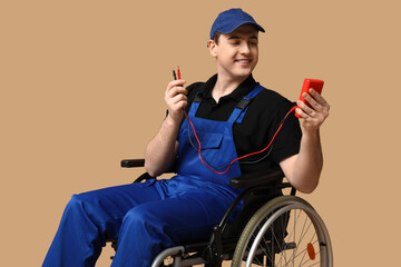 Poster - Male electrician in wheelchair with multimeter on beige background