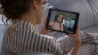 © stockbusters - Woman talk remote tablet conference at home closeup. Joyful sister waving hand