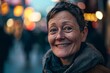 © Stocknterias - Portrait of a smiling senior woman in the street at night.