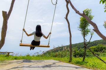 Wall Mural - Woman play swing in countryside