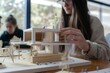 © Ahmed - Undergraduate architecture students work on models of the modern box house. Holding the part of the model while thinking about concepts of building and construction. Focusing on her hand