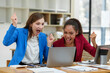 © crizzystudio - Two African business women Americans are expressing joy at the success of the financial project. Property in the office Business colleagues in the office.