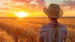© Ndoomyim - Woman in straw hat stands in wheat field, admiring a golden sunset, symbolizing tranquility, nature, and rural life.