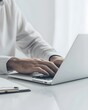 © DeepView - A closeup of hands typing on an open laptop