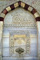 Wall Mural - Sultan Ahmed III Fountain in Istanbul: one of the marble walls decorated with carvings close-up. The architectural heritage of the Tulip Age in Turkey - landmarks in the Ottoman Baroque style.