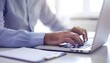 © DeepView - A closeup of hands typing on an open laptop