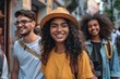 © Iigo - smiling african american girl in hat looking at camera with friends in background