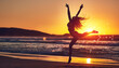 © peopleimages.com - Woman, sunset and jumping silhouette on seashore, contemporary dancing and energy in nature with dancer. Wellness, freedom and movement on summer vacation, beach and water with stretched body