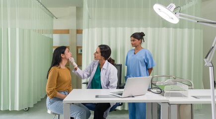 Young asian woman consulting about cosmetic surgeon and make botox injections on face for beauty procedures. Atmosphere at cosmetic surgery department in hospital clinic.