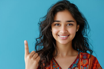 Wall Mural - young woman smiling and pointing finger