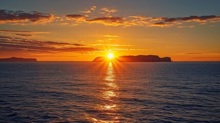 Wall Mural - the sun is setting over the ocean, casting a warm glow on the water