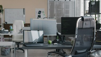Wall Mural - no people pan shot of office desk of programmer with two monitors and two laptops and green html cod