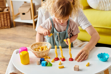 Wall Mural - Curly mother and her toddler daughter engaging in Montessori play and learning at home.