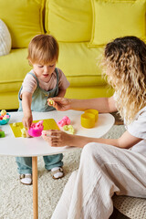 Wall Mural - A mother with curly hair and her toddler daughter are immersed in play using Montessori education at home.