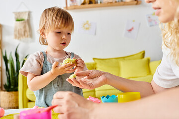 Wall Mural - A mother with curly hair and her toddler daughter engage in playful activities with Montessori toys at home.