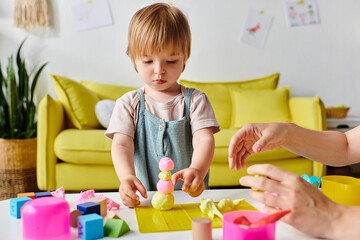 Wall Mural - mother and toddler daughter interact with Montessori toys, fostering creativity and learning at home.