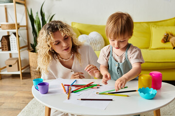 Wall Mural - A curly mother and her toddler daughter sit at a table using crayons for Montessori education.