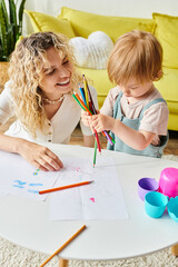 Wall Mural - A curly mother and her toddler daughter bonding over crayons using the Montessori method of education at home.