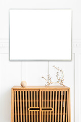 Wall Mural - Blank picture frame on a wooden cabinet
