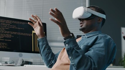 Wall Mural - medium shot of african american male engineer using ar headset while developing new game or program 