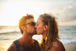 © Lyndon Stratford/peopleimages.com - Man, woman and kiss at beach for sunset, travel and vacation to island in summer for love. Happy, couple and affection for holiday with sunshine, smile and people together for date in Thailand