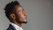 © standret - Confident young man in formal attire side profile view against grey background