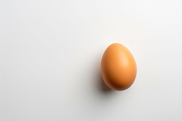 Wall Mural - an egg on a white surface with a shadow