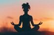 © Mike - A silhouette of a woman meditating in the lotus position, capturing a serene and tranquil moment