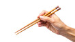 © Uncle-Ice - A hand holding wooden chopsticks isolated on white background, a traditional utensil for eating Asian cuisine like sushi