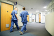 © Connect Images - Two healthcare workers walking in a hospital corridor, medical practice UK