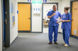 © Connect Images - Two healthcare workers consulting in hospital corridor, medical practice UK