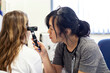 © Connect Images - Doctor conducting an ear examination in a medical practice