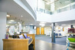 © Connect Images - Reception area of a modern hospital with an information desk.
