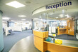 © Connect Images - Modern hospital reception area with curved desk and signage.