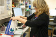 © Connect Images - Pharmacist organizing prescription medicines at work.
