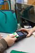 © Connect Images - A person making a payment at a reception desk of a hospital