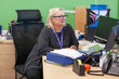 © Connect Images - Woman smiling at work with computer and papers in the office of a medical practice