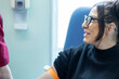 © Connect Images - Smiling woman taking a blood test from a professional