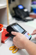 © Connect Images - Hand operating a card payment machine in a medical practice