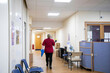 © Connect Images - Healthcare worker walking in a hospital corridor