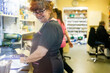 © Connect Images - Smiling woman in a medical clinic with colleagues in the background.