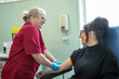 © Connect Images - Nurse preparing patient for blood draw