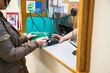 © Connect Images - Person at reception desk handing over a bank card  in medical practice