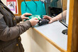 © Connect Images - Person at reception desk handing over a bank card  in medical practice